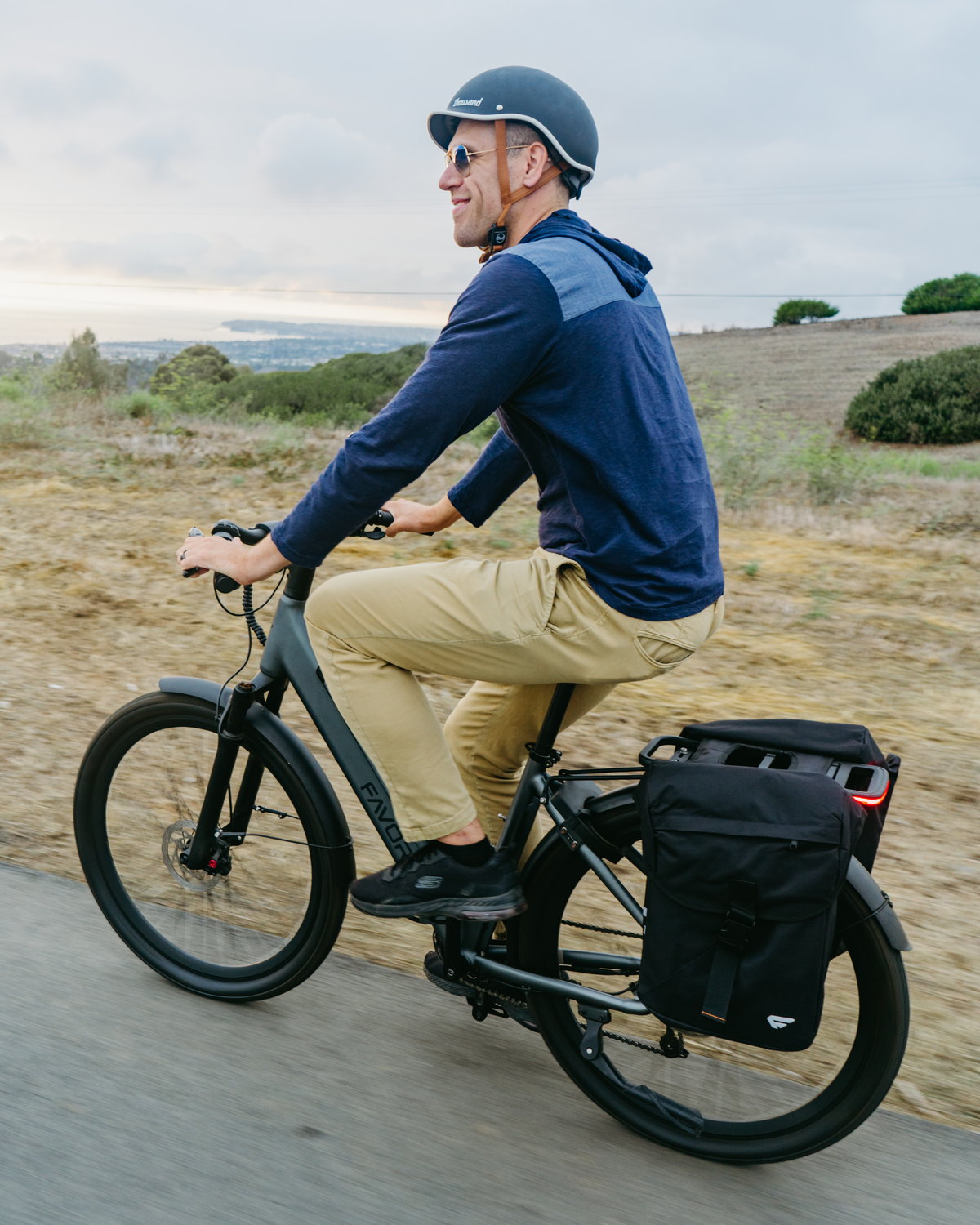 A rider commuting on a FavoriteBikes Hybrid CSC step-through electric bike