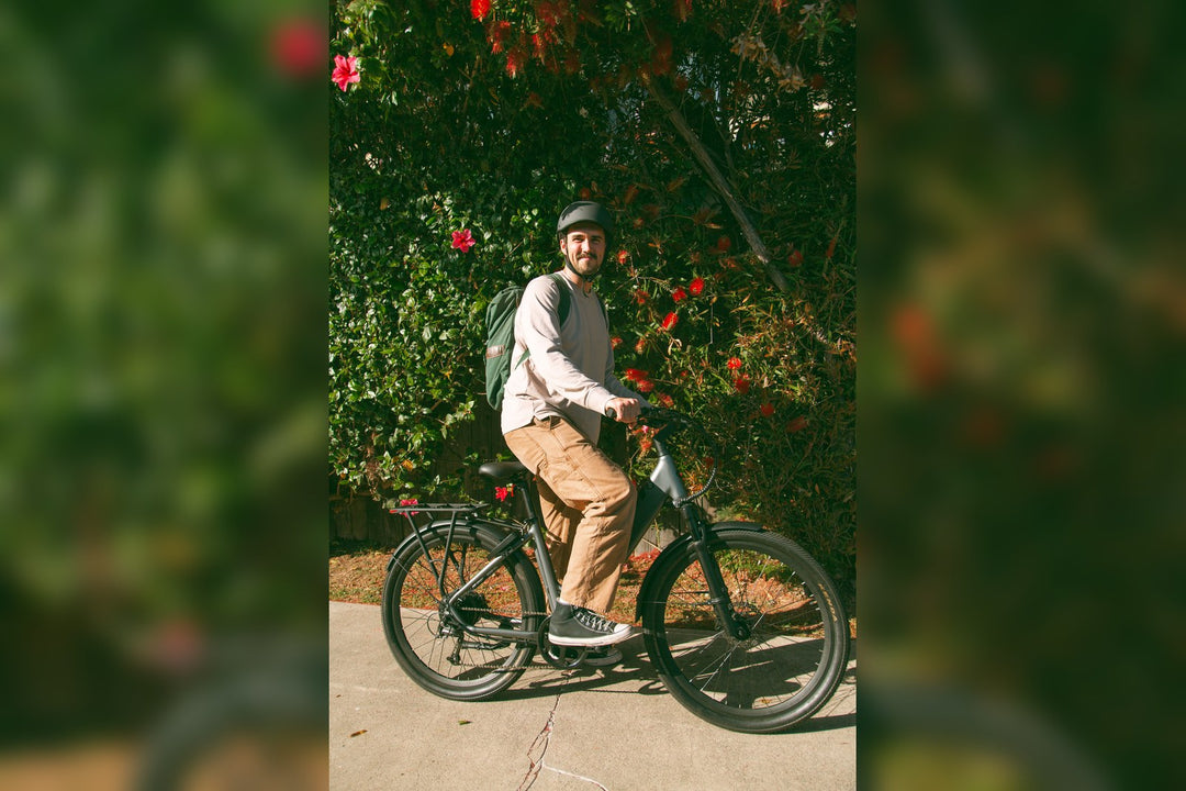 A rider with a backpack on a FavoriteBikes e-bike, illustrating everyday carry choices for backpack versus pannier setups.