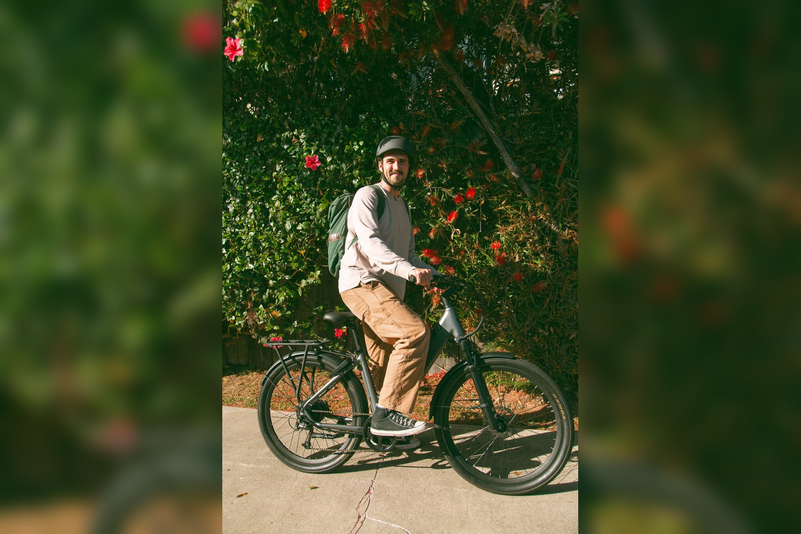 A rider with a backpack on a FavoriteBikes e-bike, illustrating everyday carry choices for backpack versus pannier setups.