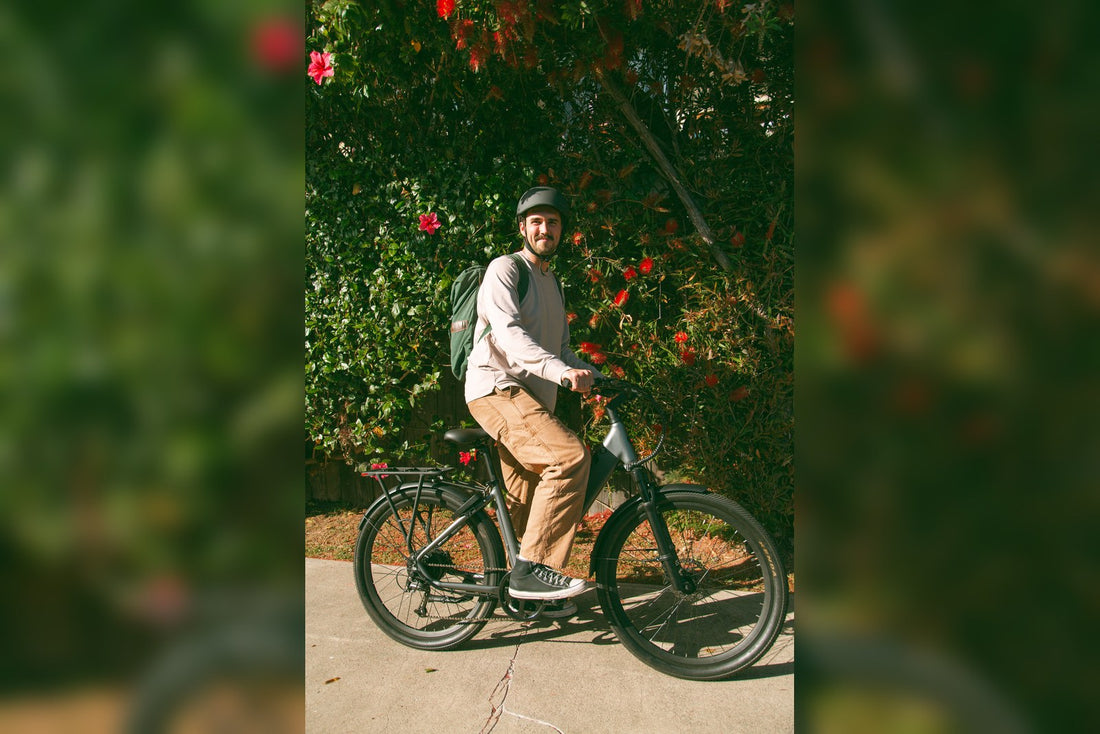 A rider with a backpack on a FavoriteBikes e-bike, illustrating everyday carry choices for backpack versus pannier setups.