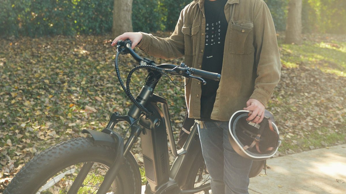 Black bicycle helmet airing on a ventilated wooden shelf between rides