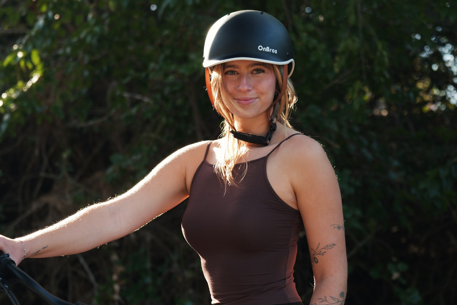 FavoriteBikes rider wearing a helmet on a bright outdoor route, illustrating eyewear and visibility comfort for daily e-bike rides.
