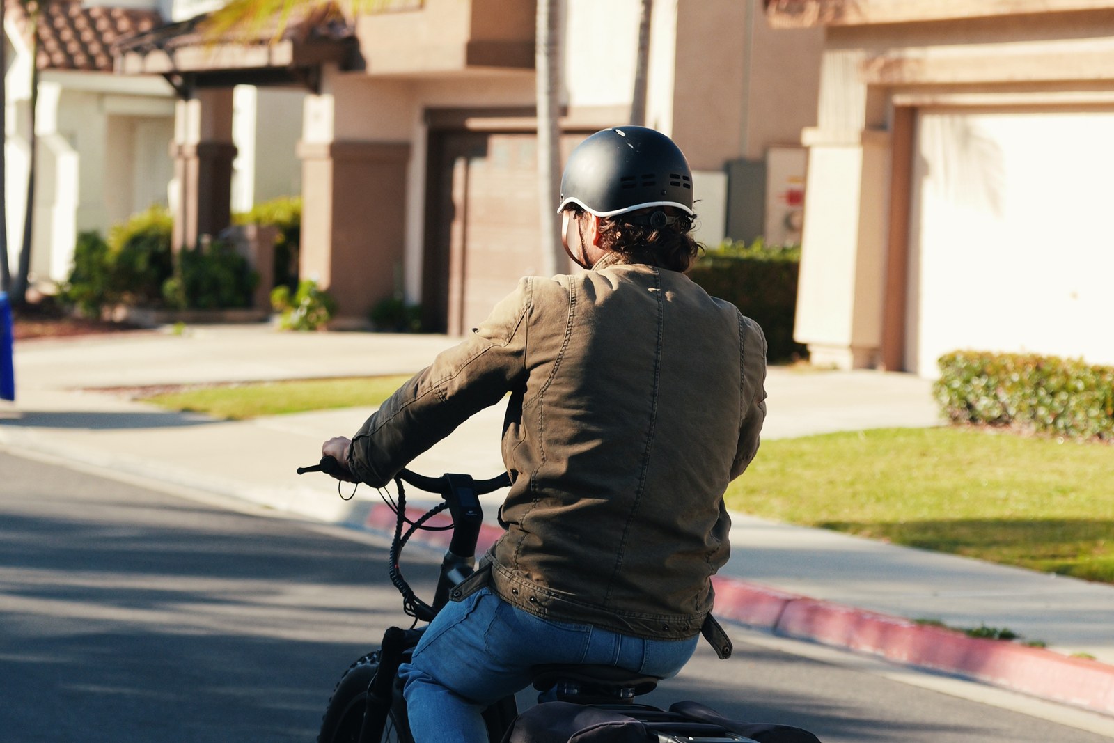 Rider on a FavoriteBikes e-bike in a neighborhood setting, illustrating weekend errand planning by e-bike.
