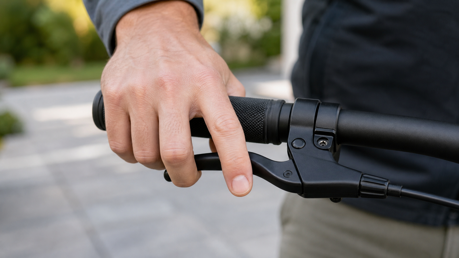 Rider checking e-bike brake lever reach on a handlebar grip