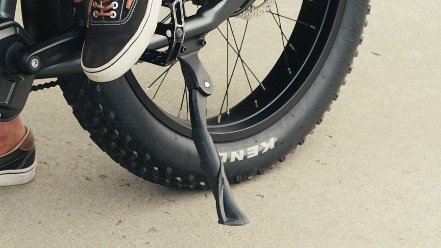 Close-up of an e-bike kickstand and rear wheel
