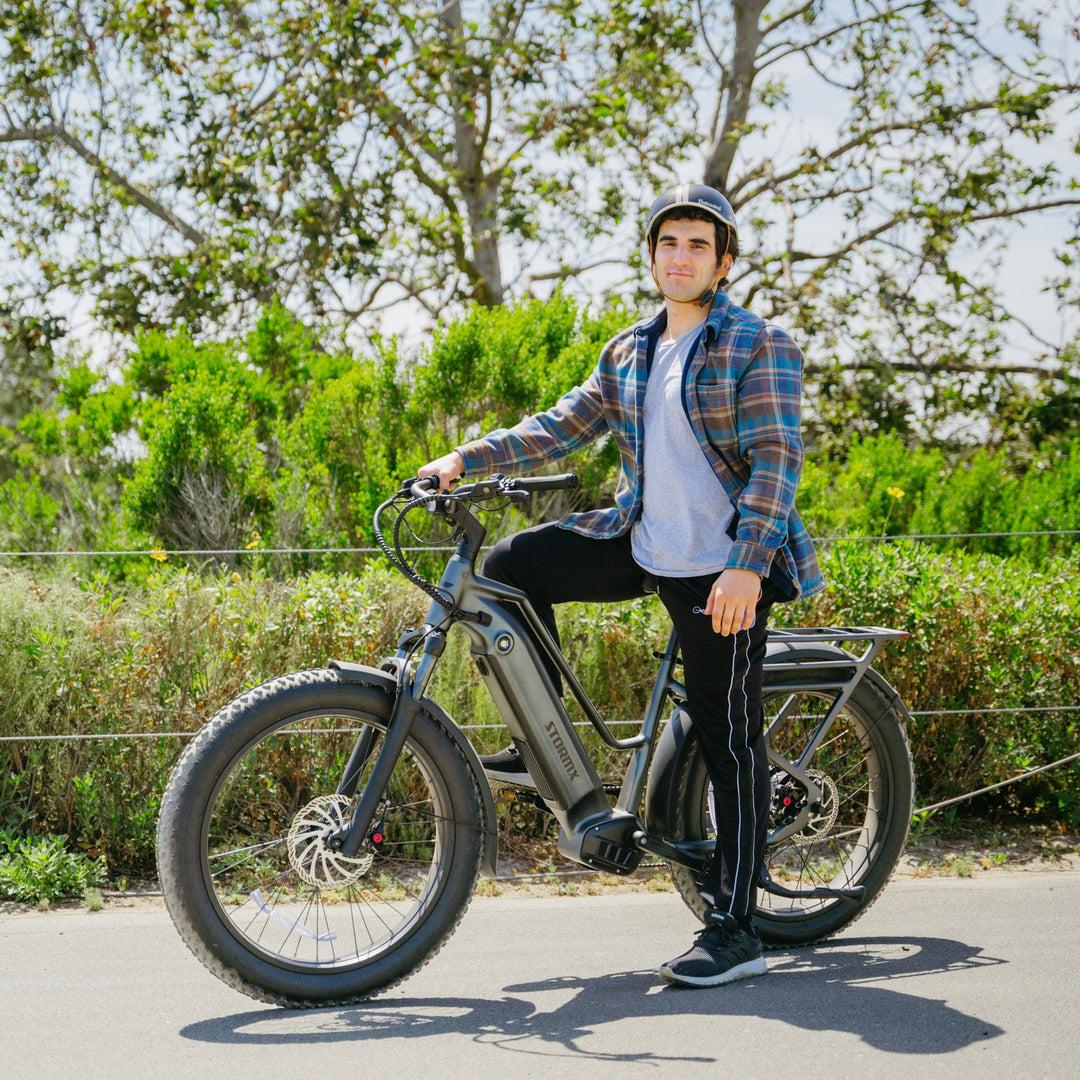 Rider with FavoriteBikes StormX fat tire e-bike on a paved path, showing everyday riding and outdoor use.