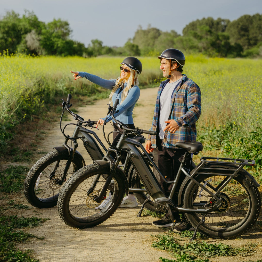 Riders with FavoriteBikes StormX fat tire e-bikes on a trail, showing all-terrain riding use.