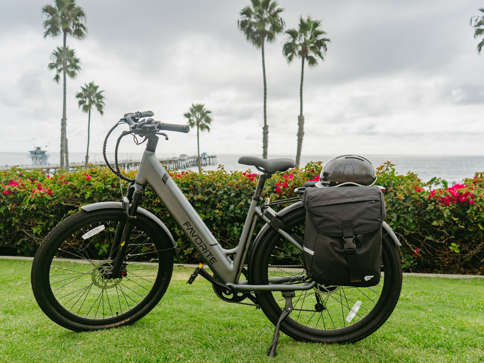 FavoriteBikes Hybrid CSC step-through e-bike fitted with black rear panniers on a hillside path