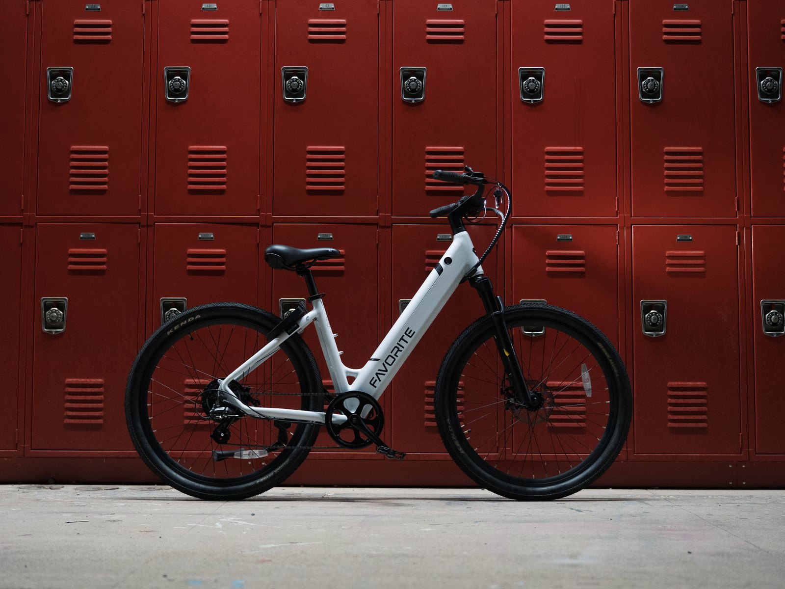 FavoriteBikes Hybrid ST step-through electric bike against a red locker wall