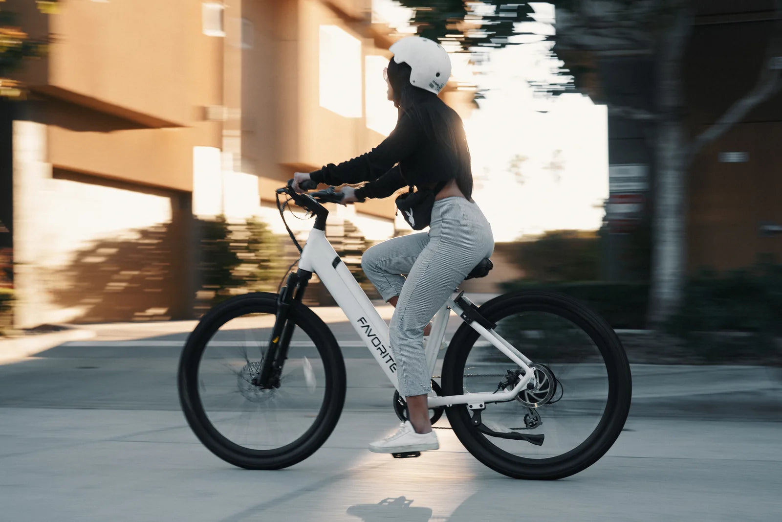 Rider commuting on a white FavoriteBikes Hybrid ST electric bike