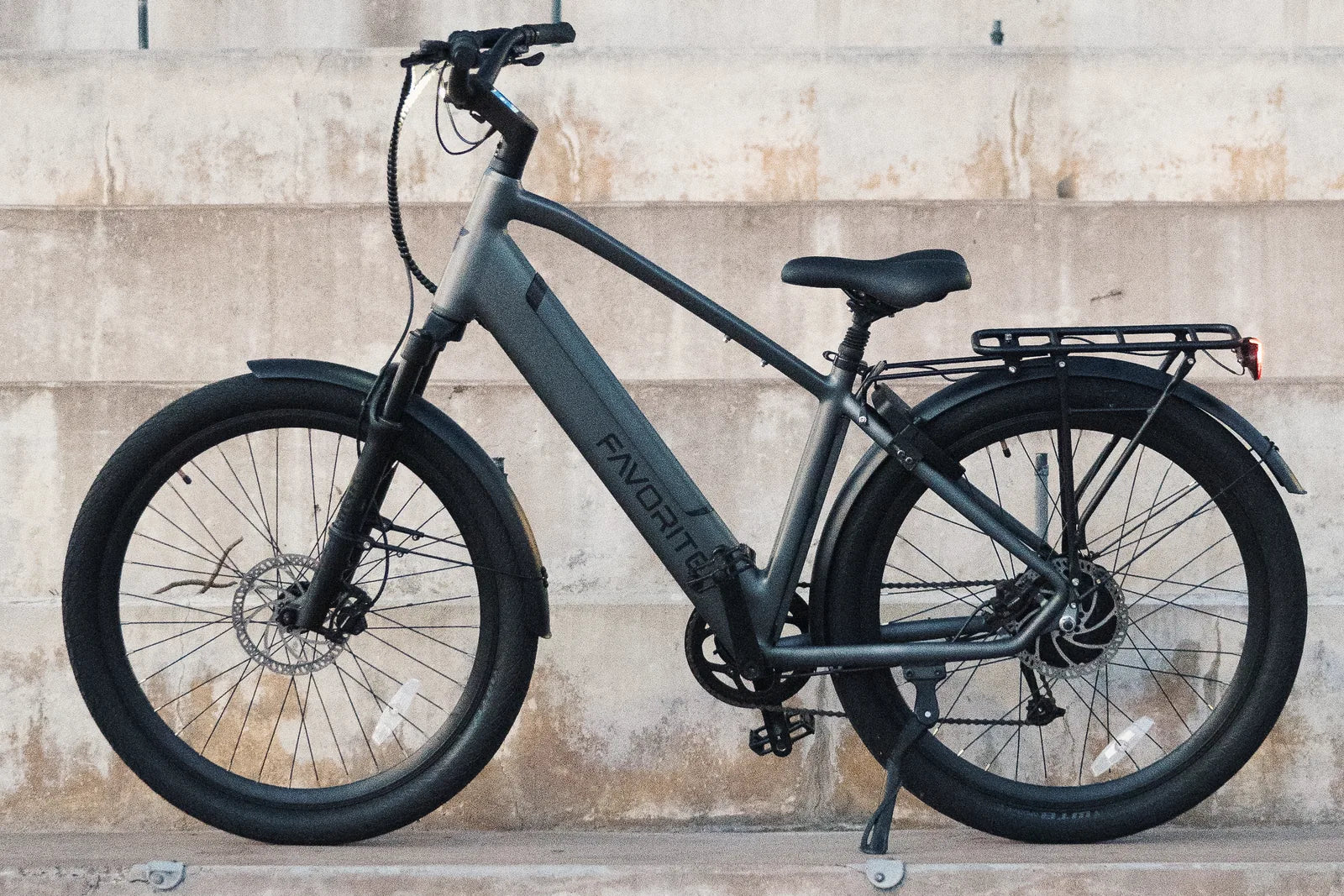 Gray FavoriteBikes Hybrid Pro XR electric bike shown in side profile on concrete steps