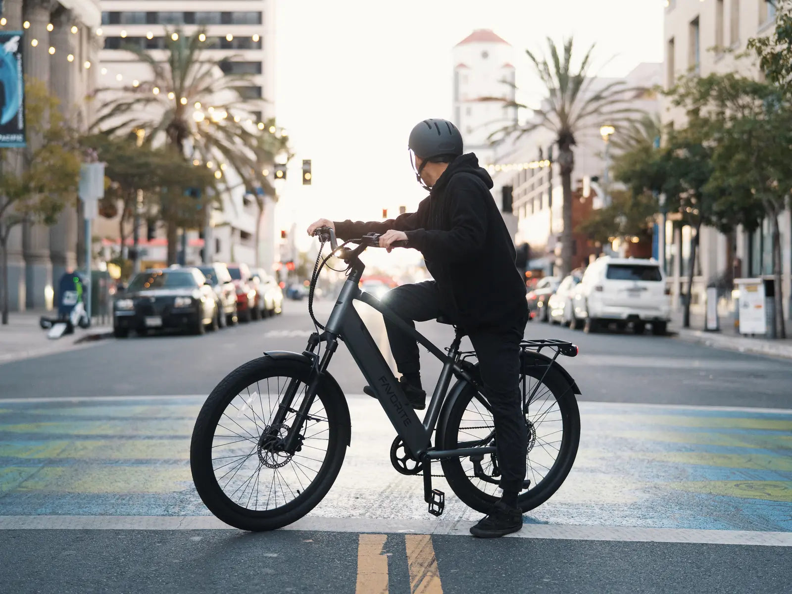 Rider on a dark FavoriteBikes Hybrid Pro crossover electric bike in the city