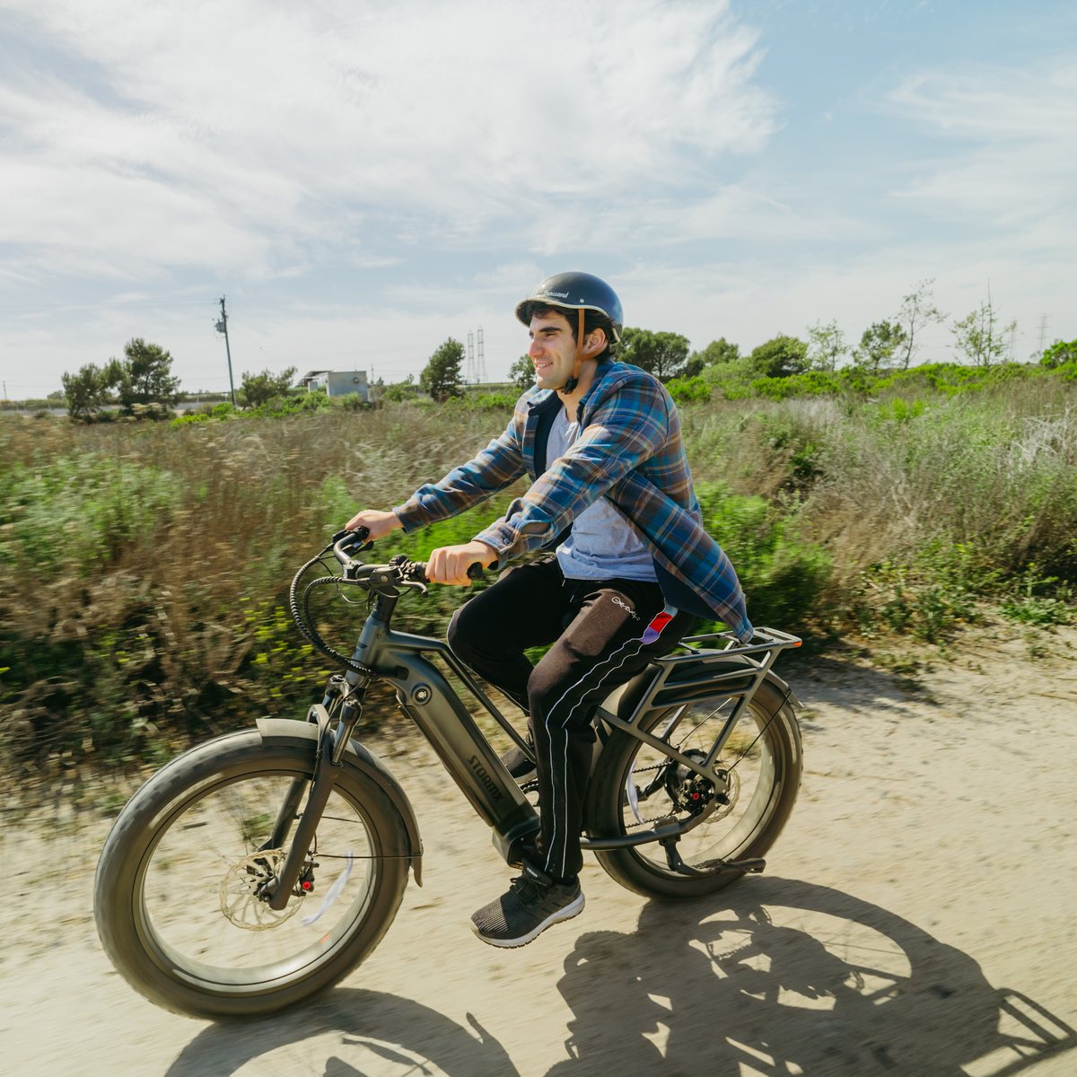 Rider taking a FavoriteBikes StormX e-bike along an off-road trail