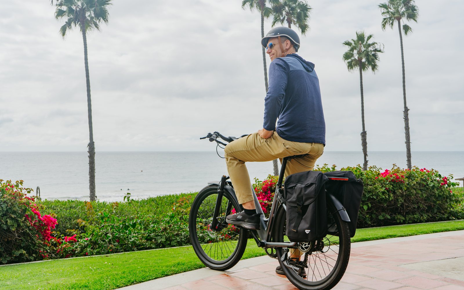 Rider on a FavoriteBikes Hybrid CSC commuter e-bike by the coast